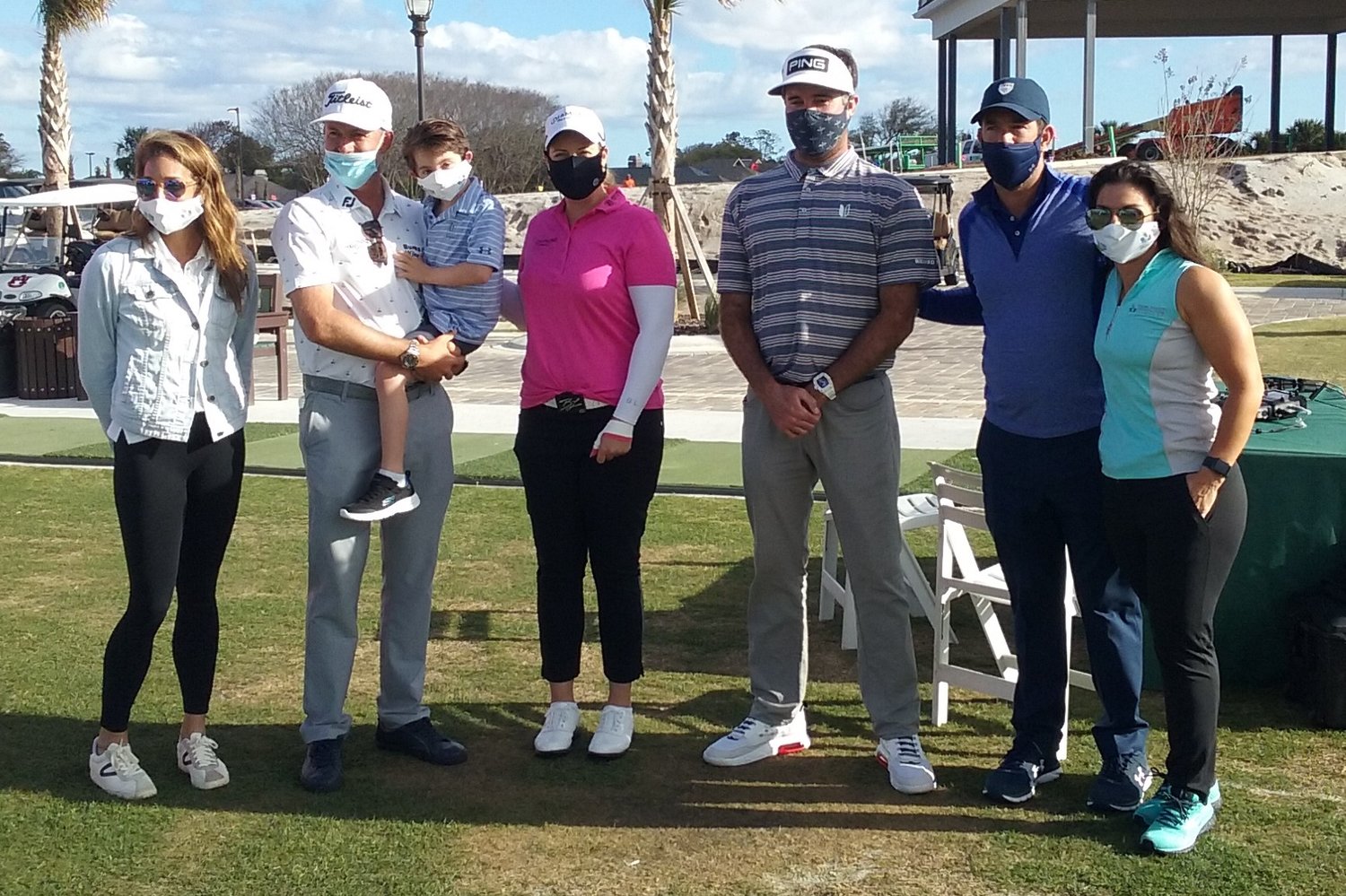 At the Tesori Family Foundation All-Star Kids Clinic on March 10 are, from left: foundation Executive Director Genna Lancaster, Webb Simpson holding Isaiah Tesori, Brittany Lincicome, Bubba Watson, Paul Tesori and Michelle Tesori.