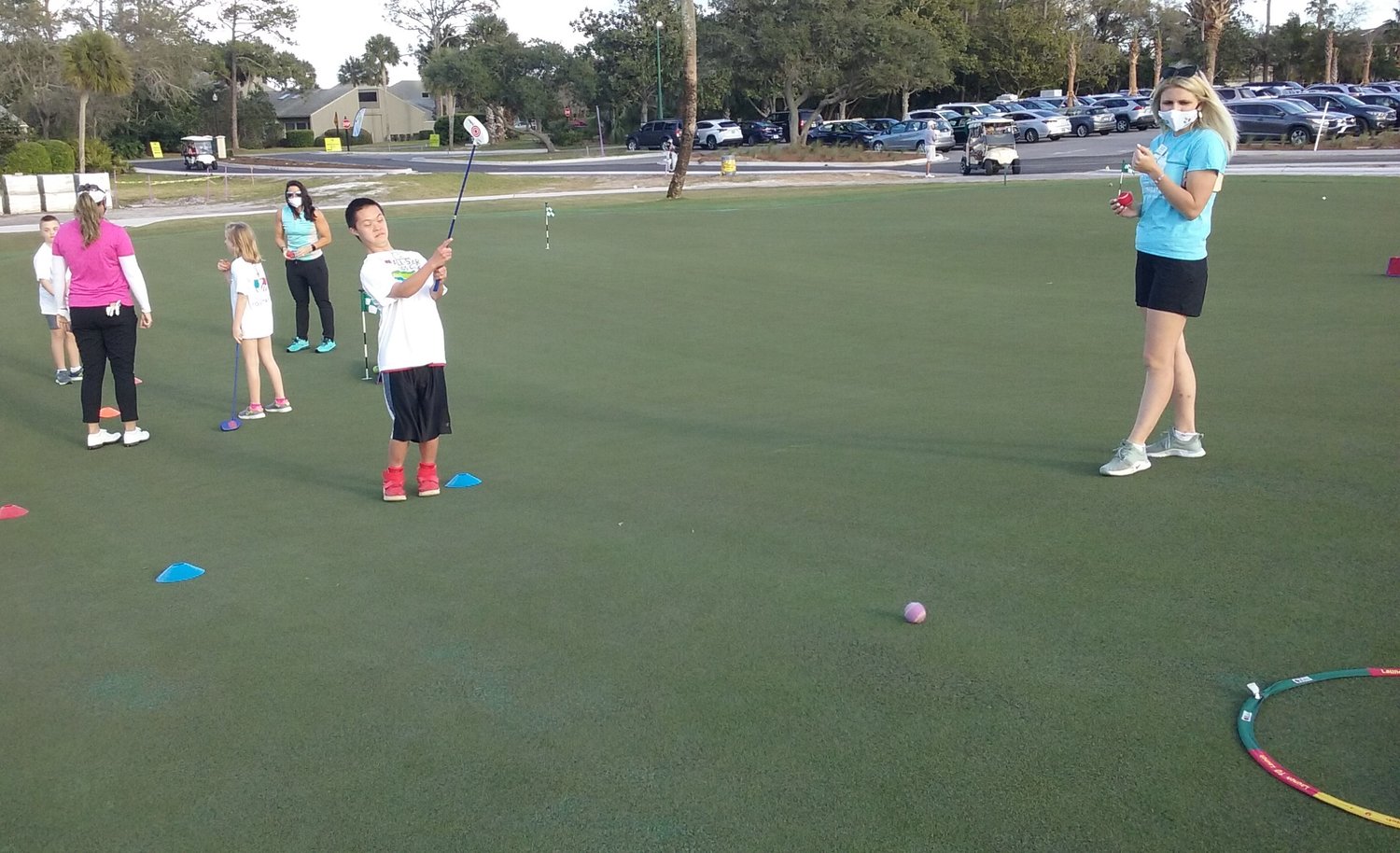 A young golfer makes a successful putt during the Tesori Family Foundation All-Star Kids Clinic on March 10.