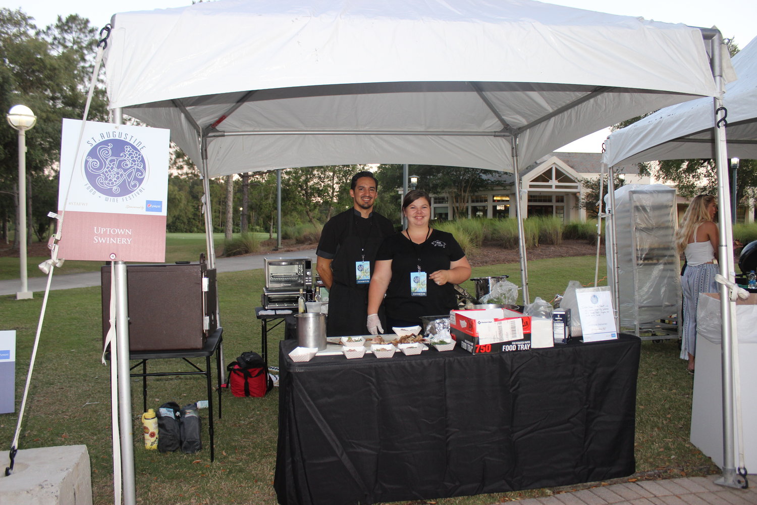 Representatives from Uptown Swinery serve up barbecue during last year’s Smoke on the Walk event.