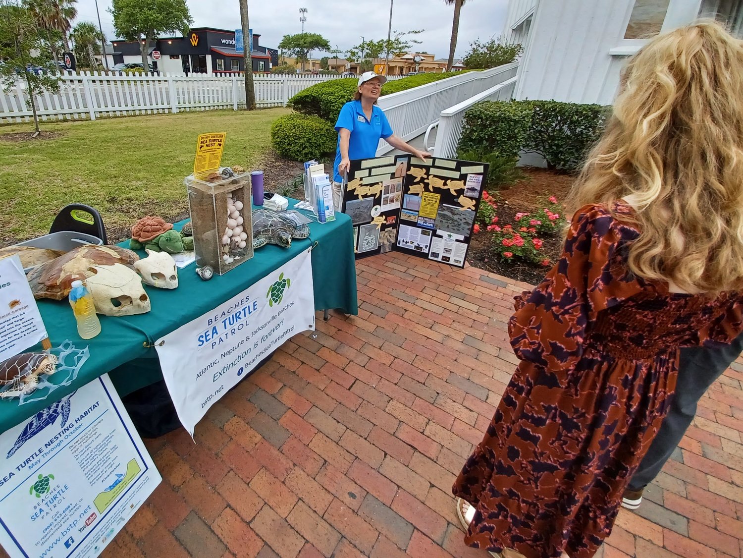 A representative of the Beaches Sea Turtle Patrol speaks to visitors during the Beaches Museum’s “Springing the Blooms” event.
