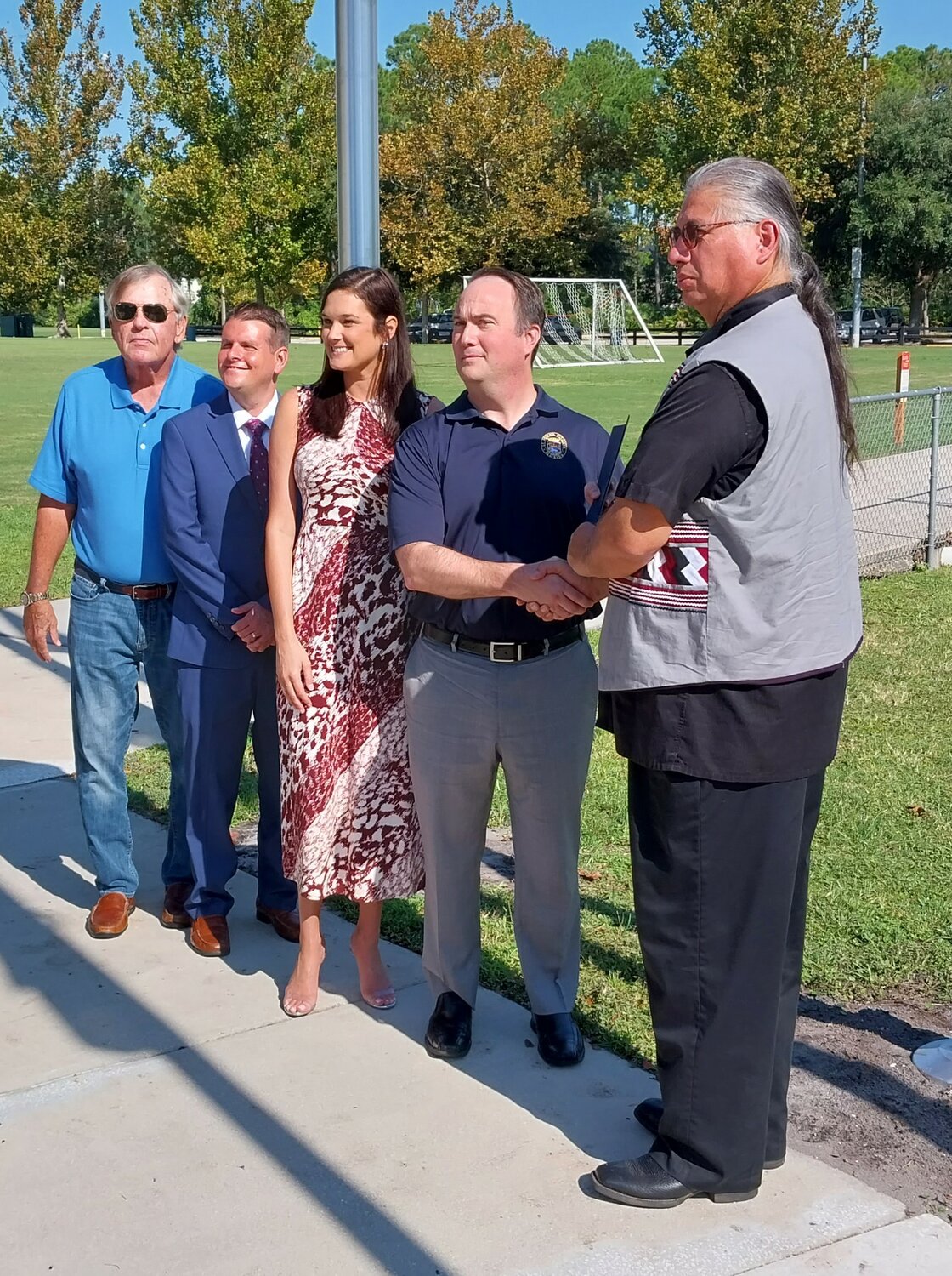 St. Johns County Commissioners Henry Dean, Roy Alaimo, Sarah S. Arnold and Christian Whitehurst, from left, stand for a photo with Principal Chief Lewis Johnson of the Seminole Nation of Oklahoma.